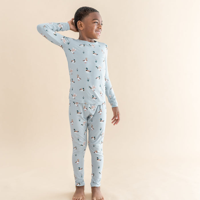 Young boy posing wearing the Long Sleeve Pajamas in Mallard Duck