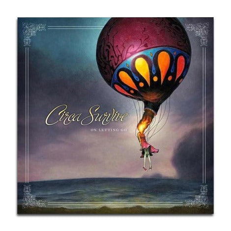 A surreal painting of a figure hanging from a large, ornate hot air balloon over a dusk landscape. โCirca Surviveโ appears in elegant cursive near the center left, evoking the ethereal vibe of this iconic music album.