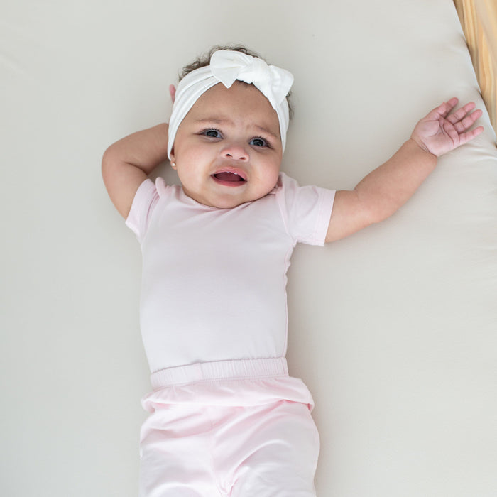 Infant wearing Kyte Baby Harem style Pant in Sakura