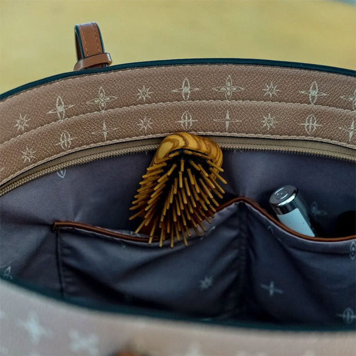 Small wooden hairbrush inside pocket of purse