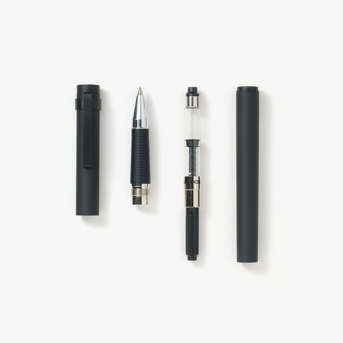 Rollerball pen taken apart with converter on white background