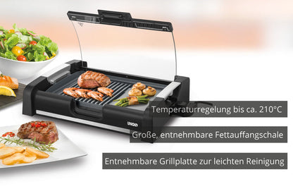 Der Unold Barbecue-Grill Edel ist ein elektrischer Tischgrill mit transparentem Deckel, Grillfleisch und Gemüse, einer Salatschüssel in der Nähe, Temperaturregelung bis 210 °C und abnehmbarem Grillrost und Fettauffangschale zur einfachen Reinigung.
