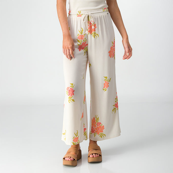 Front view of Belladona Pant in white with floral print, paired with tan platform sandals for beach-inspired comfort.