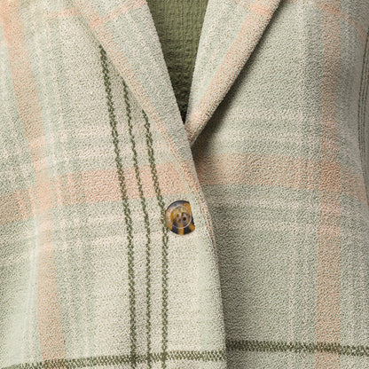 Close-up of the olive green and beige plaid Beverly Knit Trench showing textured fabric and button detail.