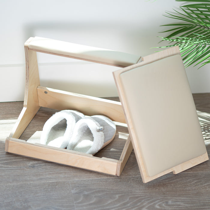 A birch wood footrest with a white cushion on top and storage compartment beneath.