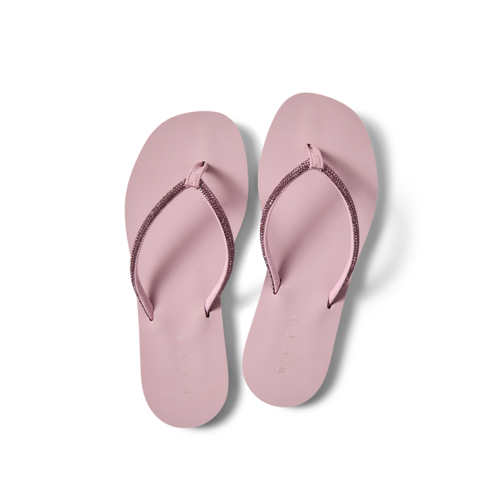 Bliss Bling Fling women's pink flip flops top view, facing upward, with soft-rebound cushioning and arch support for beach comfort.