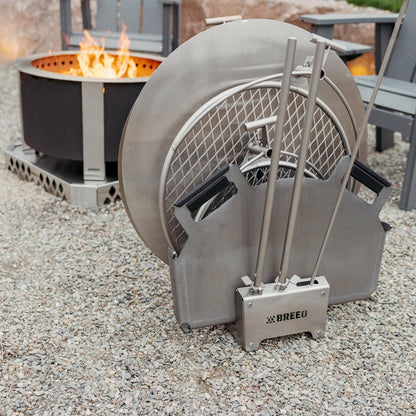 Breeo 304 Dock with a metal basket and tools on a gravel surface.