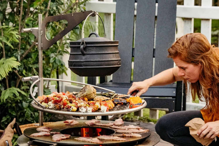 Grilling on an X Series fire pit with a Kettle and Kettle Hook attached