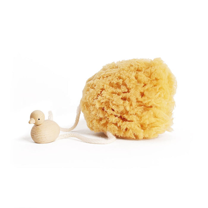Yellow sponge with a small wooden duck attached on a white background