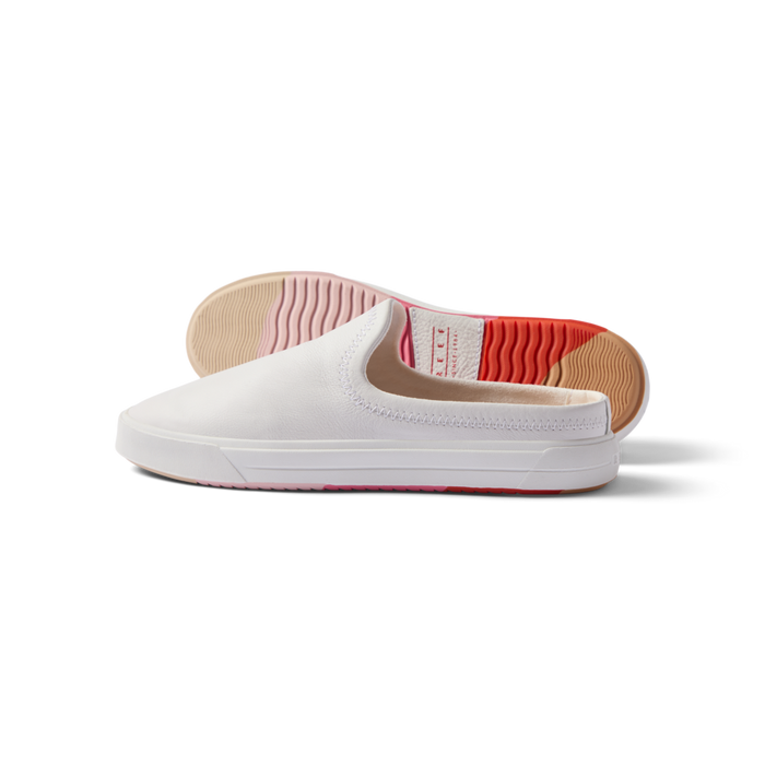 Coastal Breeze women's white slip-on shoe facing left with heel view showing water-friendly sole and arch support.