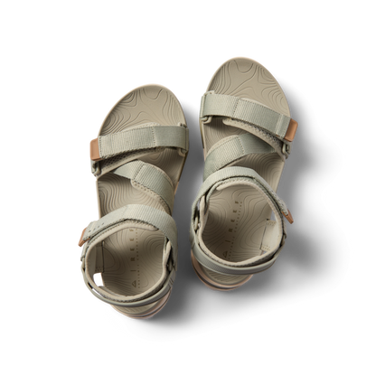 Top view of Cross-Shore men’s sandals in tan with adjustable straps, soft cushioning, and arch support for beach comfort.