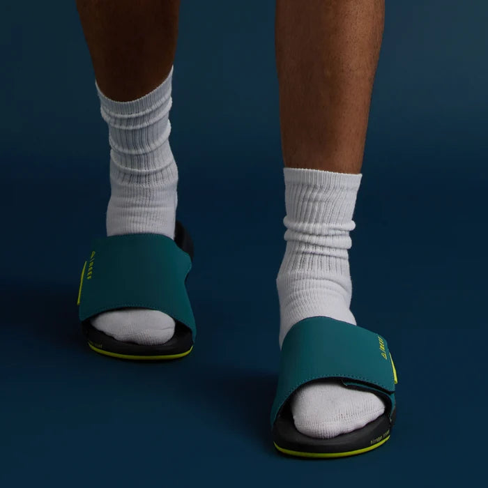 Front view of men's Cruiser Slide in ocean lime color, showing cushioned footbed and comfortable beach-inspired design.