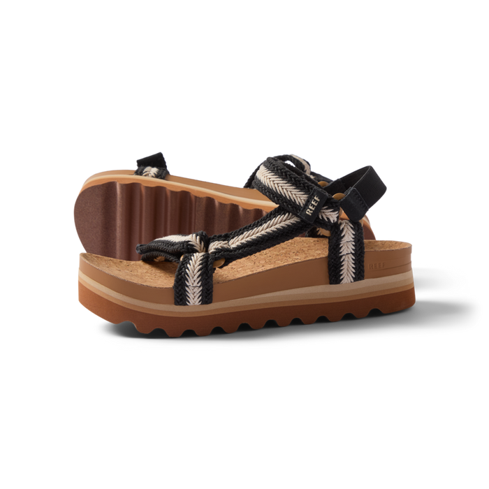 Pair of Cushion Rem Hi sandals for women facing right, braided straps, soft cushioning, and textured soles for beach comfort.
