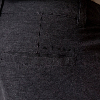 Close-up of the back right pocket of the black Destro Hybrid Short for men, showcasing breathable, comfortable beach apparel.