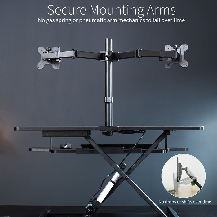 Sit to stand desk riser and dual monitor mount with electric height adjustment.