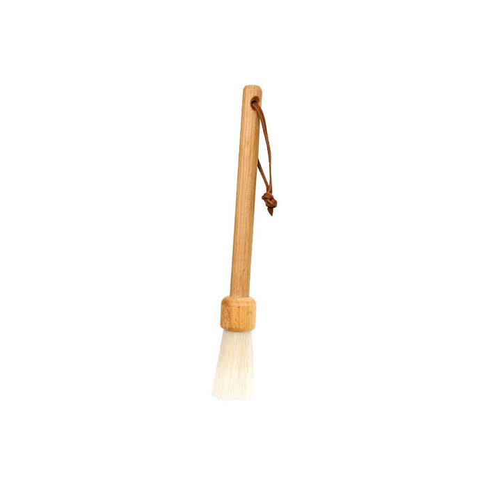 Slender wooden dust brush with light-colored bristles on white background