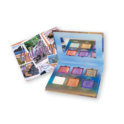 Galápagos Palette propped open displaying shadows with palette packaging visible behind on a white background.