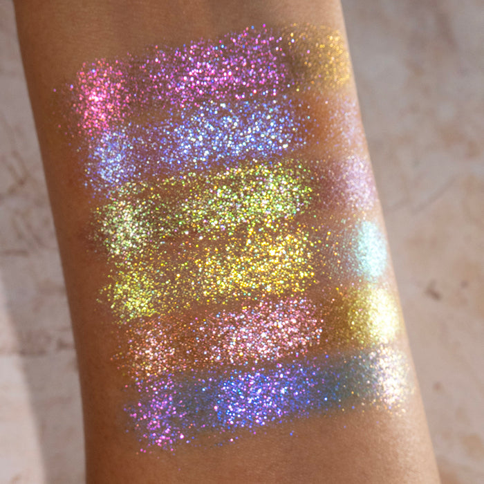 Arm swatches of all six Galápagos Palette shadows on medium skin tone on a beige background.