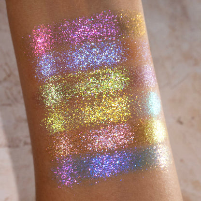 Arm swatches of all six Galápagos Palette shadows on medium skin tone on a beige background.