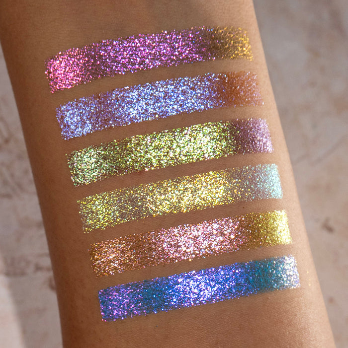 Arm swatches of all six Galápagos Palette shadows on medium skin tone on a beige background.
