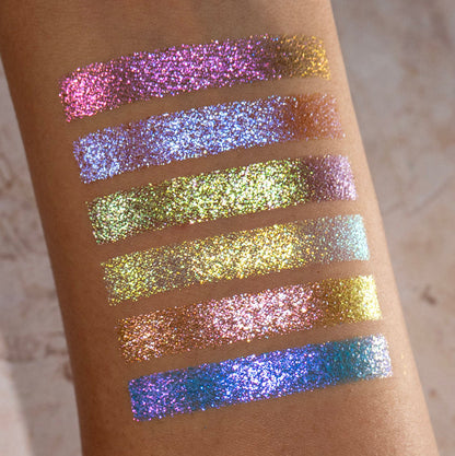 Arm swatches of all six Galápagos Palette shadows on medium skin tone on a beige background.