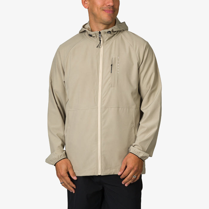 Man wearing beige Garvey Jacket facing front with hood, lightweight and durable beach-inspired men's apparel.