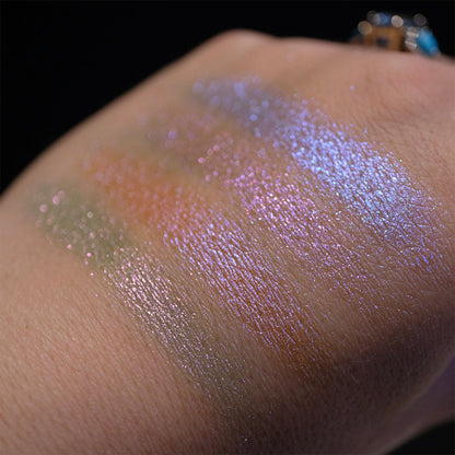 Swatches on the back of hand of all four shadows from the Glow Quad on fair skin tone with a black background.