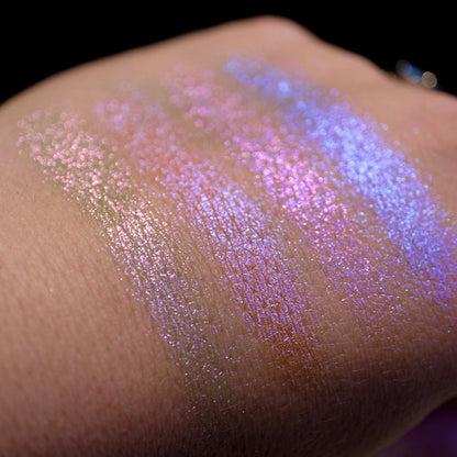 Swatches on the back of hand of all four shadows from the Glow Quad on fair skin tone with a black background.