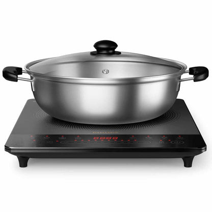 Stainless steel pot on an electric cooktop with a white background