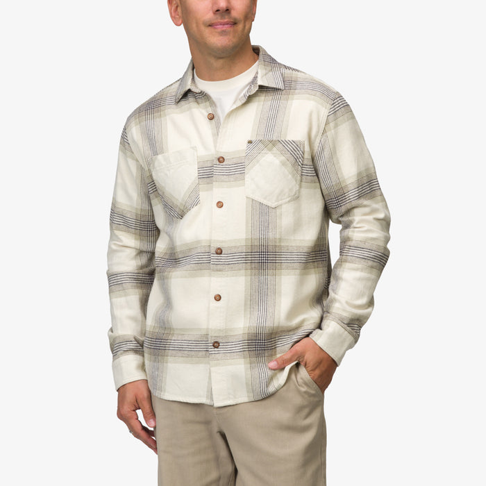 Man wearing Houston Flannel Shirt in almond with plaid pattern, front view, hands in pockets, beach-inspired casual apparel.