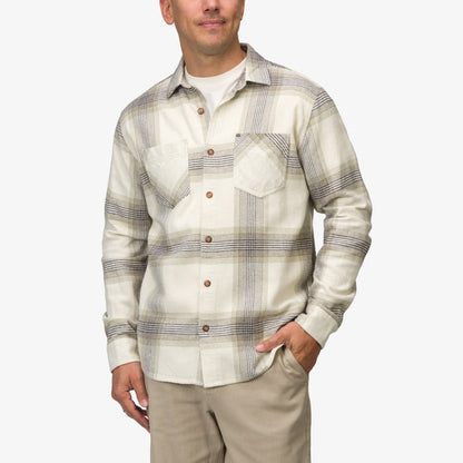Man wearing Houston Flannel Shirt in almond with plaid pattern, front view, hands in pockets, beach-inspired casual apparel.