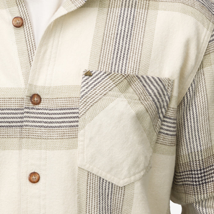 Close-up of the pocket and buttons on the Houston Flannel Shirt in almond milk with a soft plaid pattern.