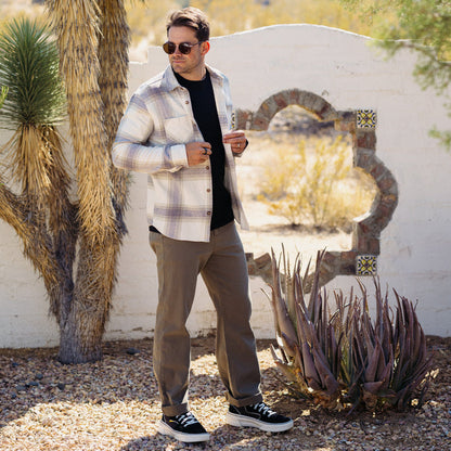 Man wearing the Houston Flannel Shirt outdoors, styled casually with sunglasses in a desert-like setting.