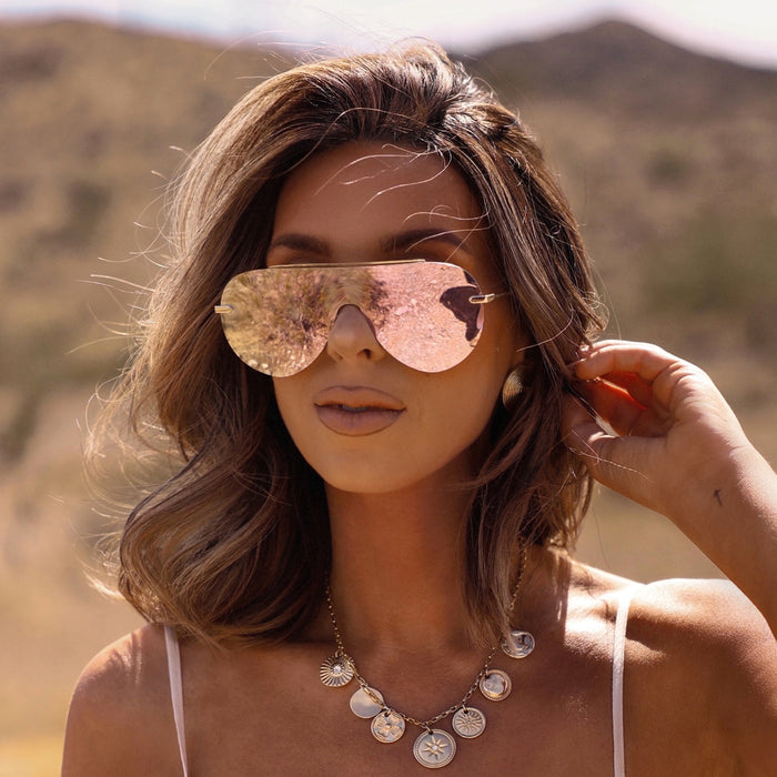 UGC - lifestyle - female wearing diff eyewear featuring the imani shield sunglasses with a gold frame and cherry blossom mirror lenses