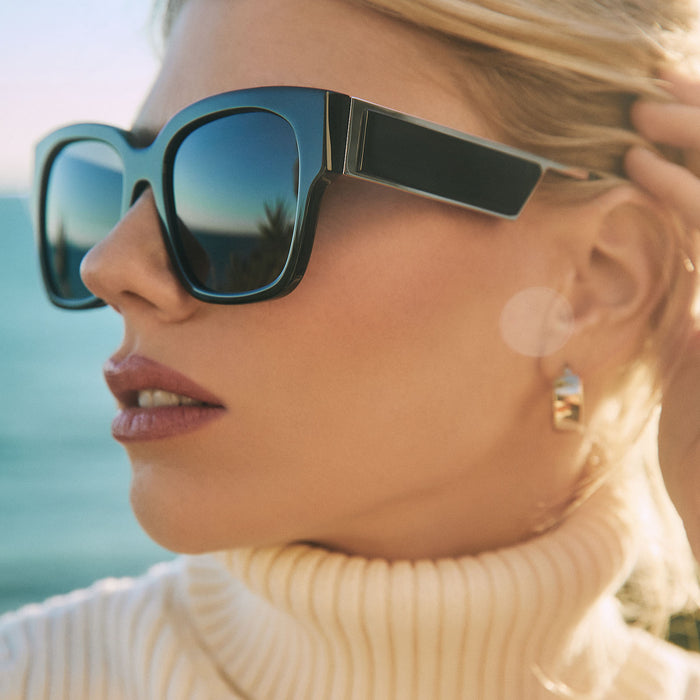 lifestyle - blonde female wearing diff eyewear isabella square sunglasses with a black frame and grey polarized lenses detailed view