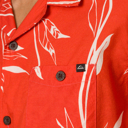 Close-up of the chest pocket and collar of the red Kaden Camp Shirt with white leaf print, showing button details.