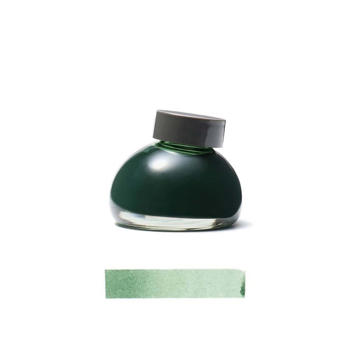 Green Kurun ink bottle with a gray cap on a white background