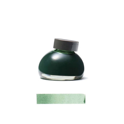 Green Kurun ink bottle with a gray cap on a white background
