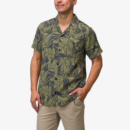 Men wearing Kantis Shirt with green and black tropical leaf pattern, front view showing relaxed fit and short sleeves.