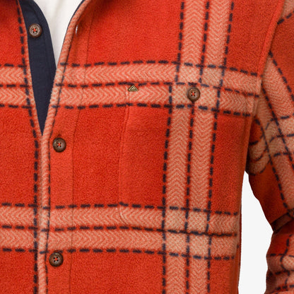 Close-up of the chest area of a men's Karter Shirt Jacket in orange plaid, showcasing comfort and surf-inspired design.