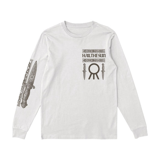 A white long-sleeve Hail The Sun shirt with the bands name and two knife graphics on the chest, a large circular symbol below, and a detailed dagger design on the right sleeve.