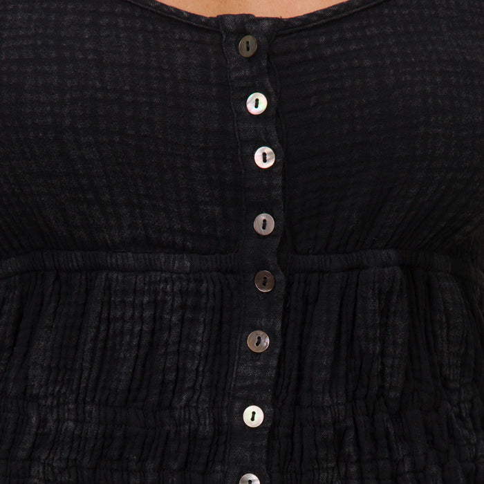 Close-up of the front button detail on the black Lainey Mini Dress from All Women's Apparel, designed for comfort and style.