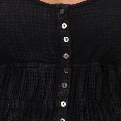 Close-up of the front button detail on the black Lainey Mini Dress from All Women's Apparel, designed for comfort and style.