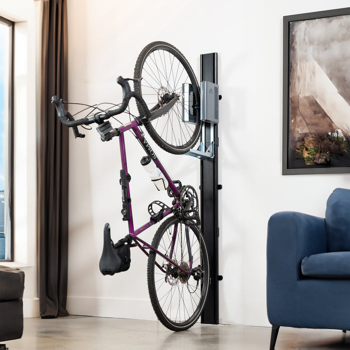 Wall mounted bike rack with mechanical lift in a living room.