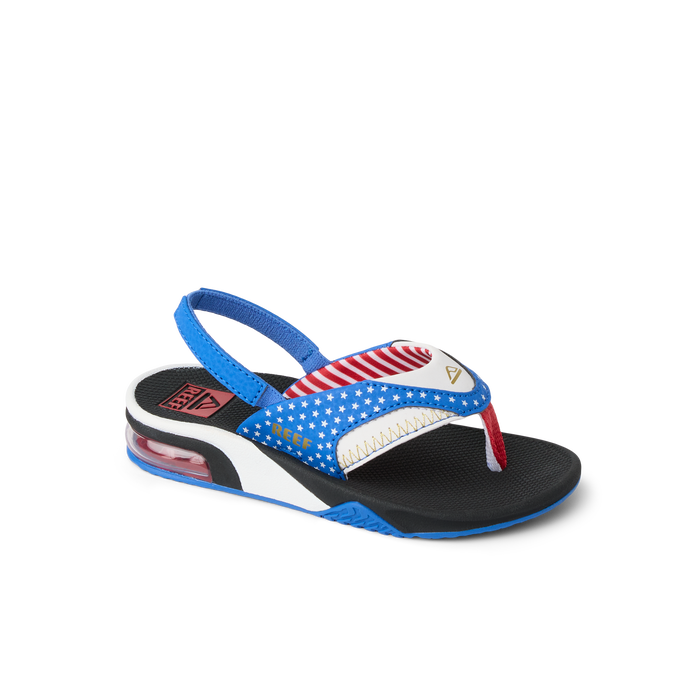 Little Fanning boys sandal facing right, close-up of toe post and blue, red, white beach-inspired design with arch support.