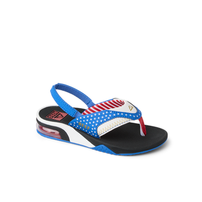 Little Fanning boys sandal facing right, close-up of toe post and blue, red, white beach-inspired design with arch support.