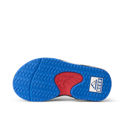 Little Fanning boys’ sandal sole facing up showing blue and red water-friendly outsole with Reef logo for comfort.