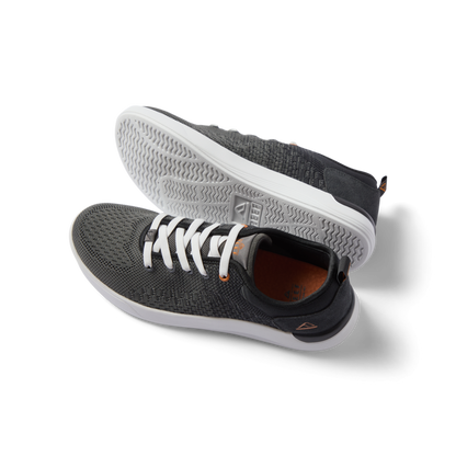 Pair of black and white Neso men's sneakers featuring anatomical arch support, soft cushioning, and rubber outsole, right shoe facing left.