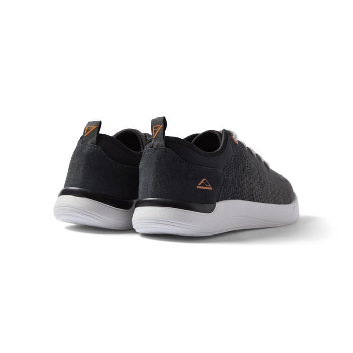 Neso men's black sneakers facing backward, showing heel with anatomical arch support and soft cushioning.