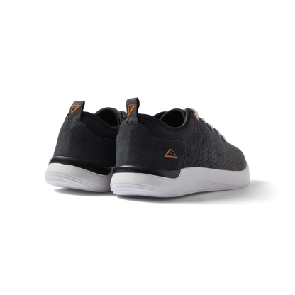 Neso men's black sneakers facing backward, showing heel with anatomical arch support and soft cushioning.
